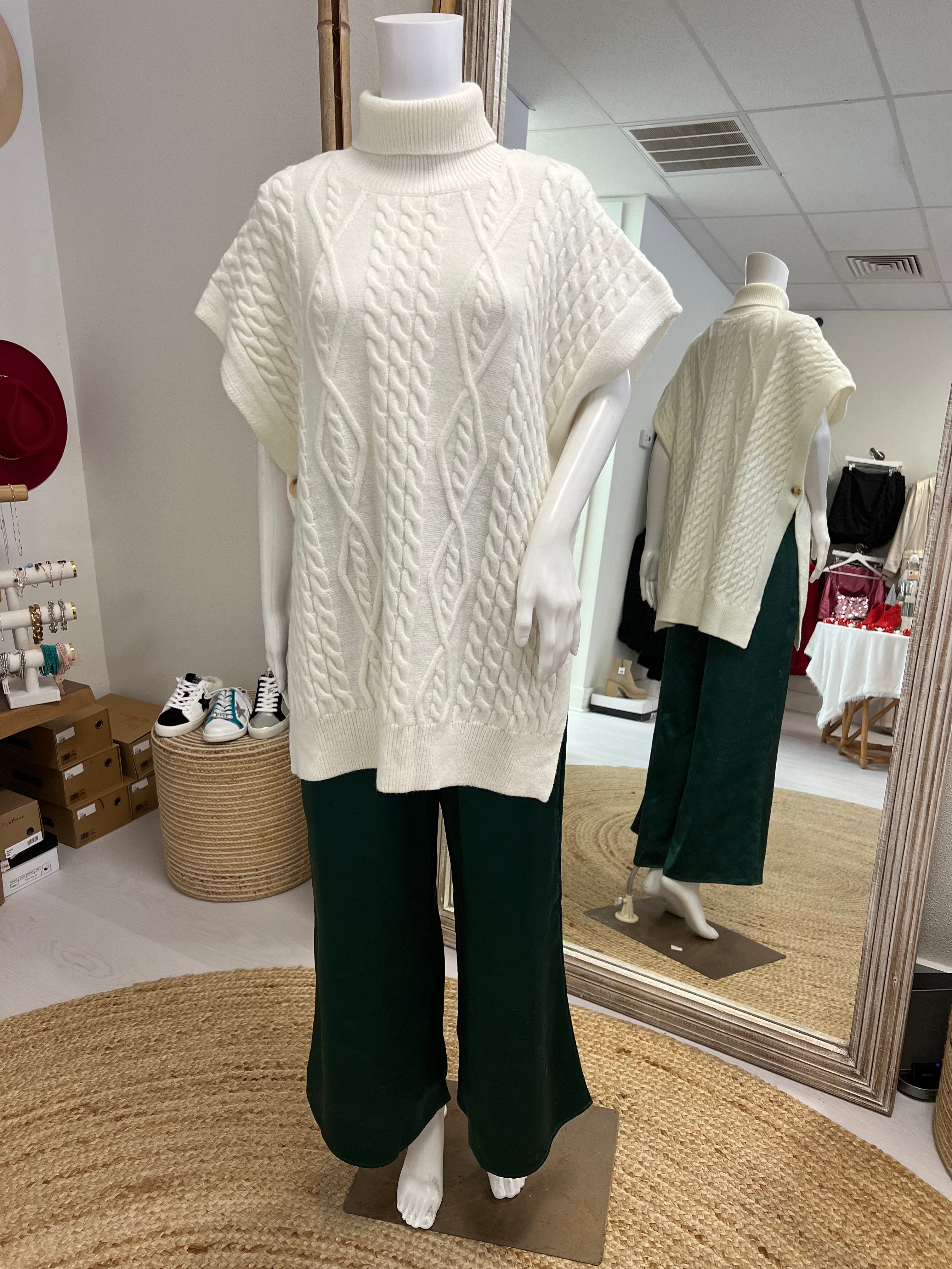 White sweater poncho vest with green pants