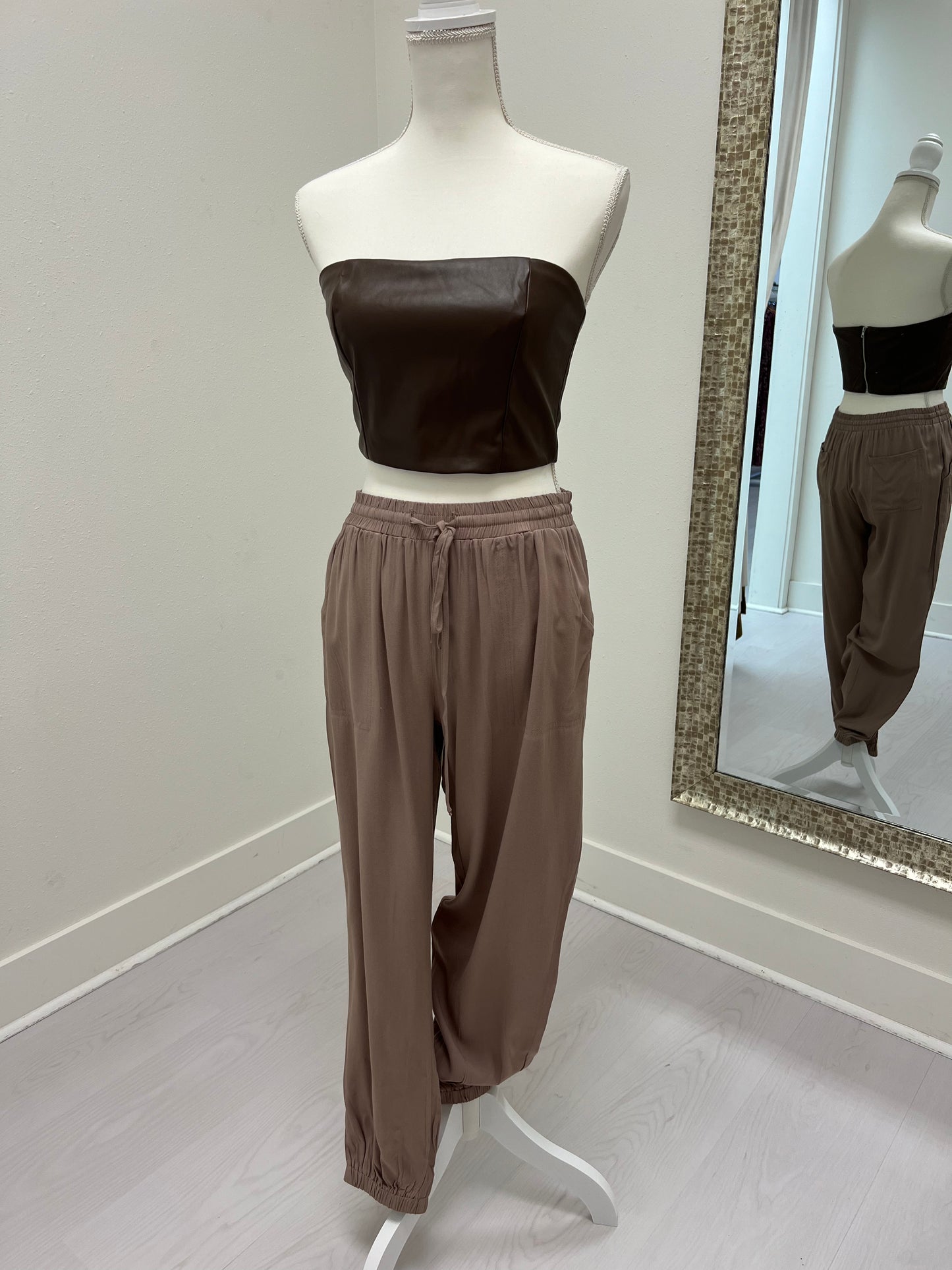 Brown leather strapless crop top with taupe joggers
