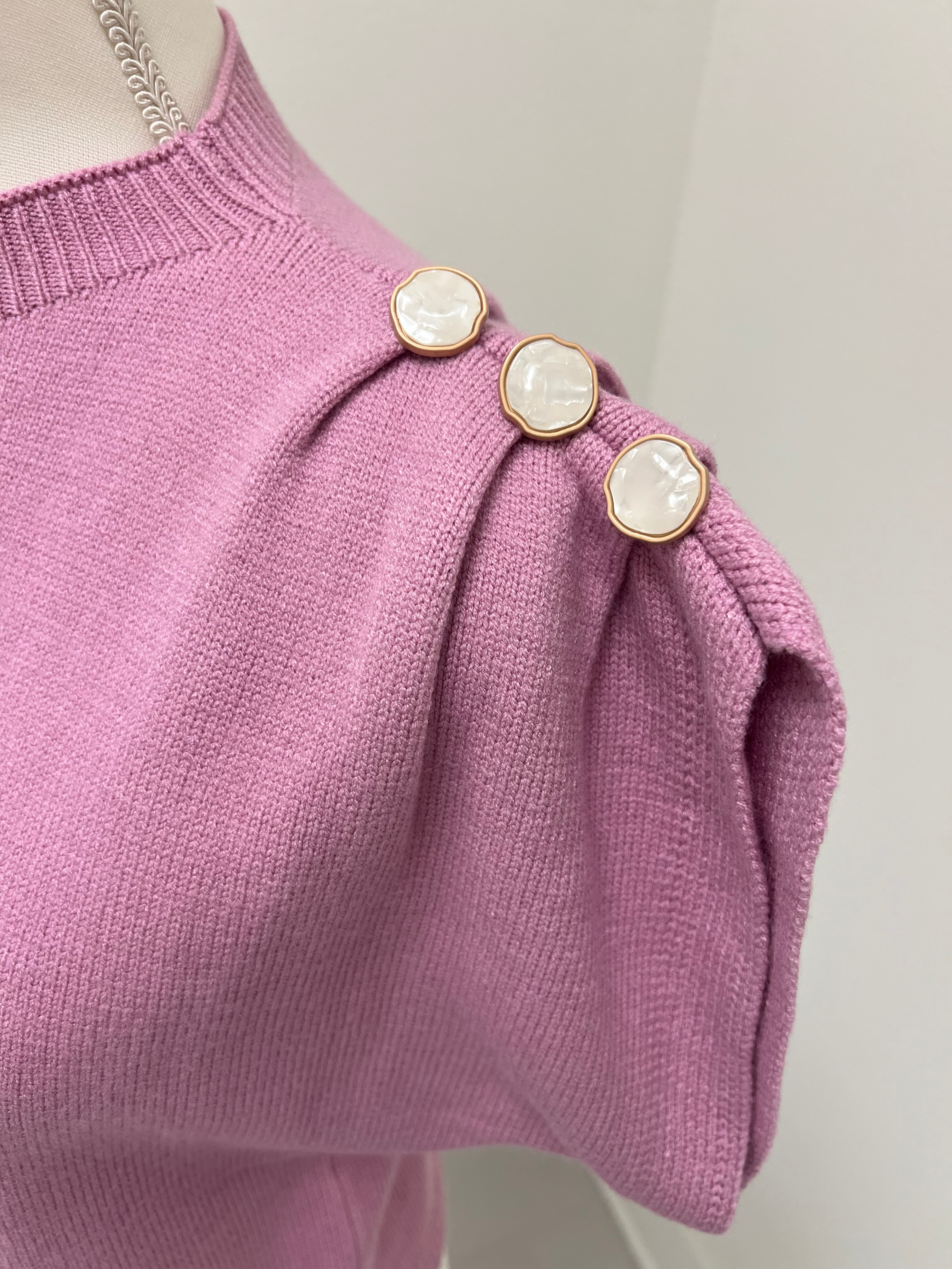 Button detail on lilac sweater sleeves