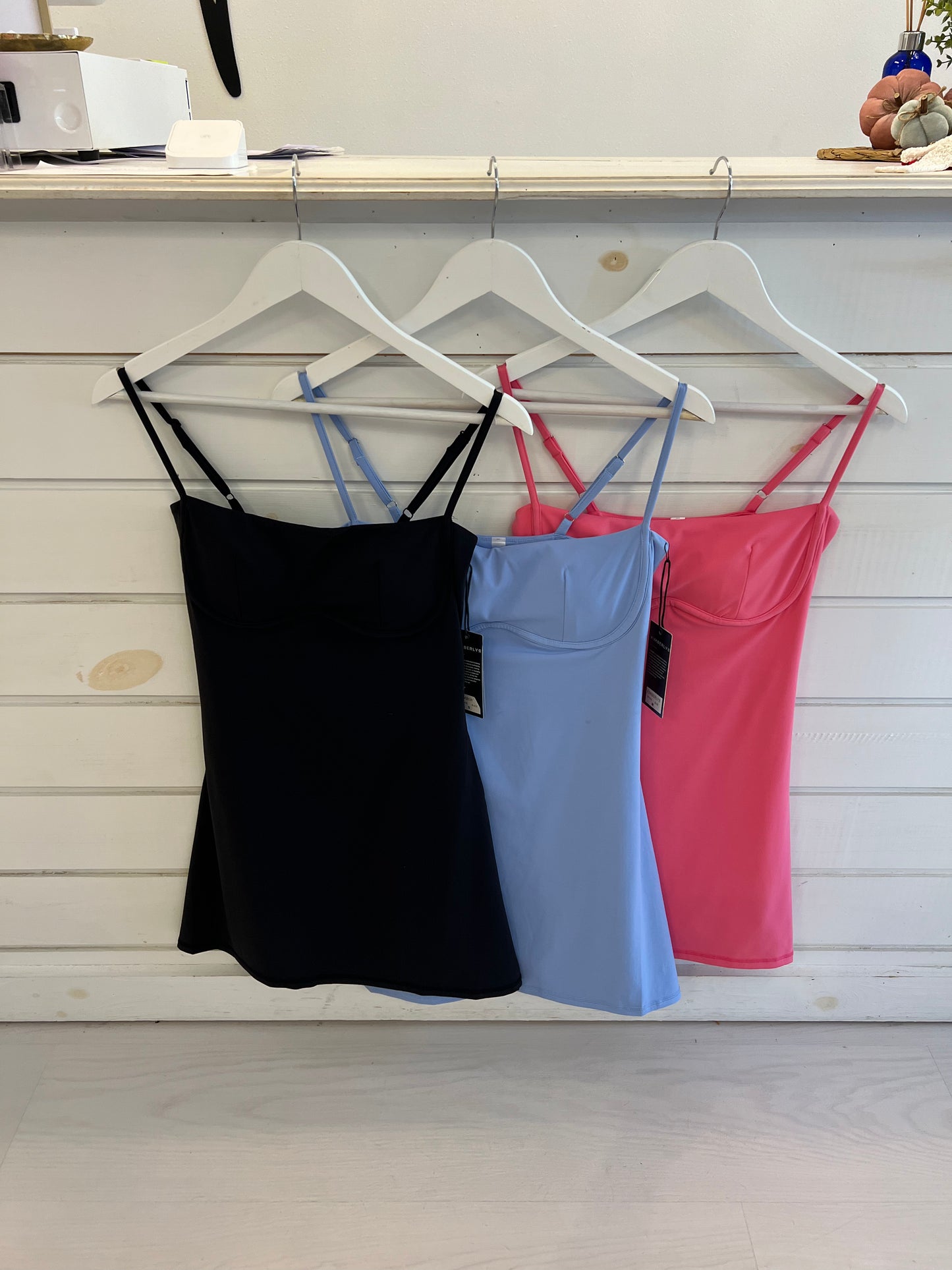 Athletic dress in black, blue, & pink